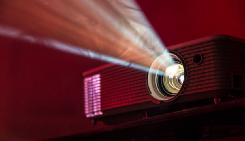 An image of a projector in a dark room.