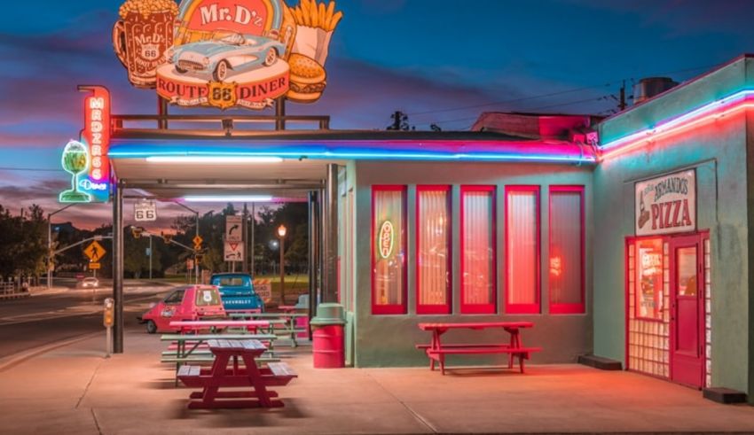 A diner with neon lights at dusk.