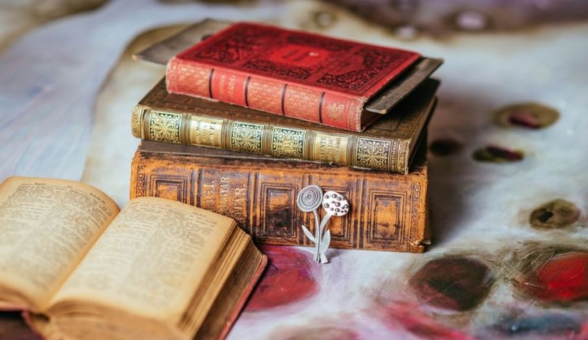 A stack of old books and a spoon on a table.