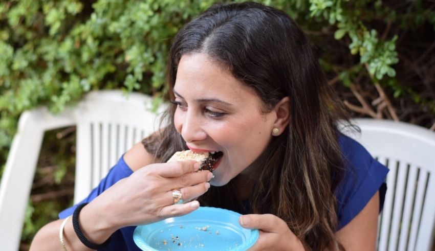 A woman eating a piece of cake on a plate.