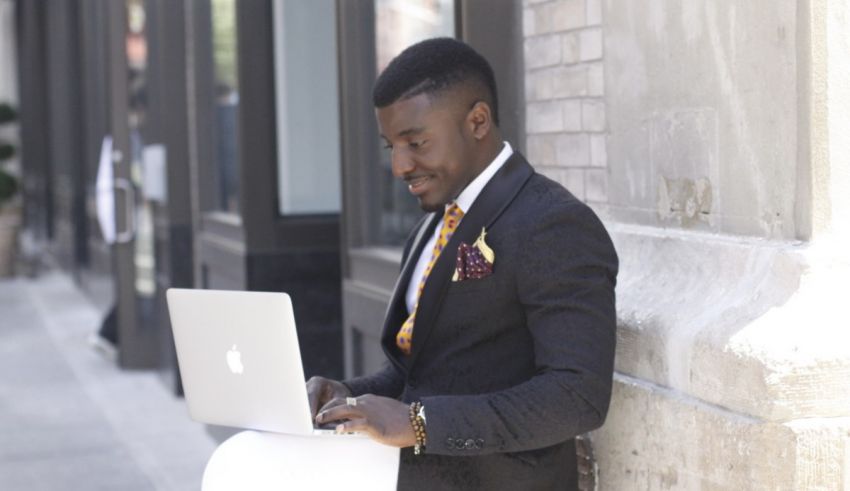 A man in a suit using a laptop.