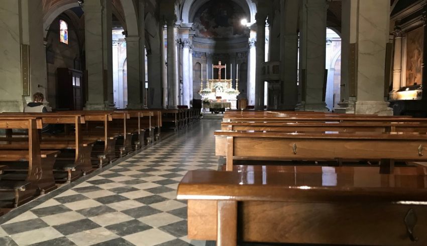 A church with benches and a cross.