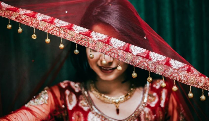 A woman wearing a red dress and a red veil.