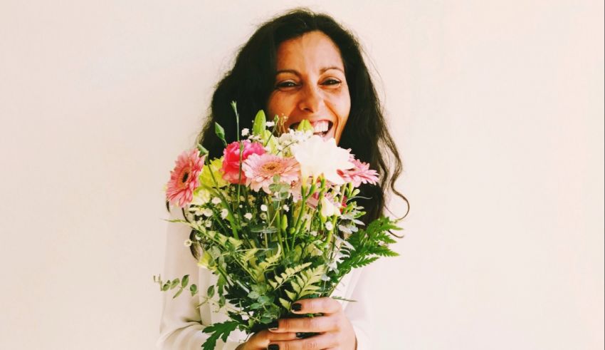 A woman is holding a bouquet of flowers.