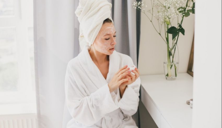 A woman in a bathrobe and a towel on her head.