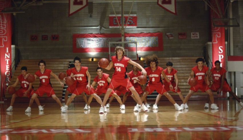 A group of young men in red uniforms on a basketball court.