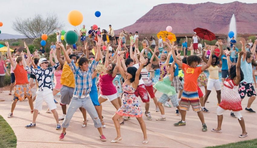 A group of people holding balloons in the desert.