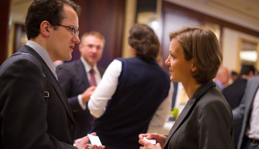 A man and woman talking at a business event.