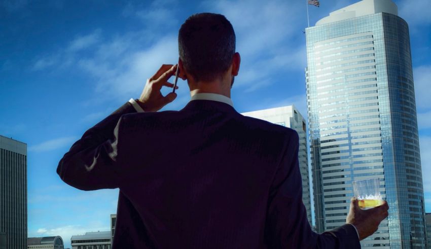 A man in a suit talking on a cell phone.