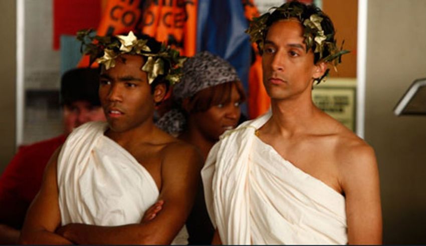 A group of men wearing white robes and gold leaves on their head.