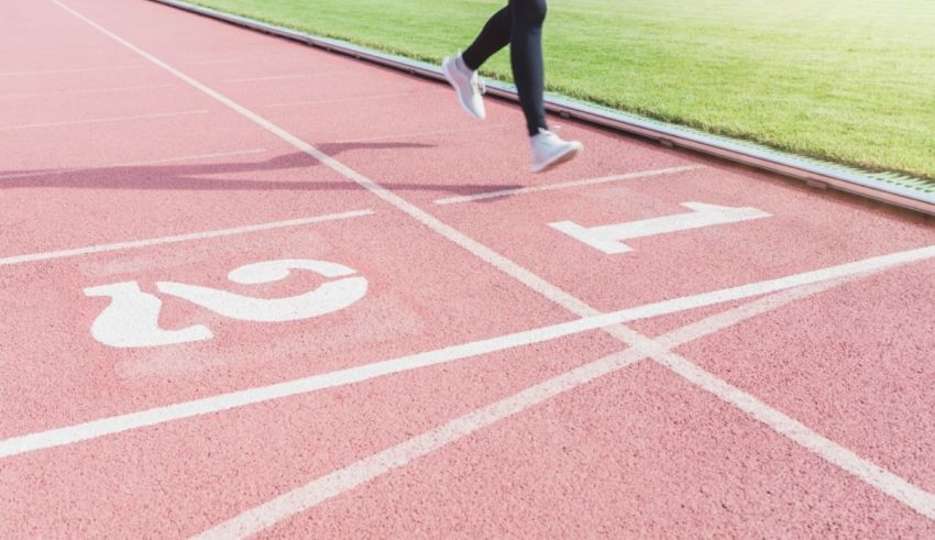 A woman is running on a running track.