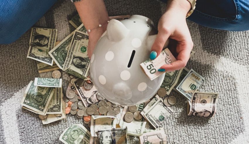 A woman is putting money into a piggy bank.