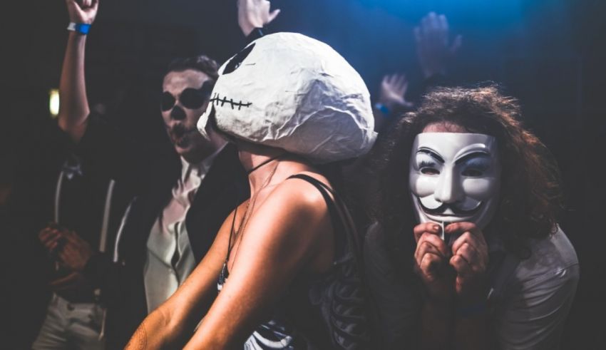 A group of people wearing masks at a party.