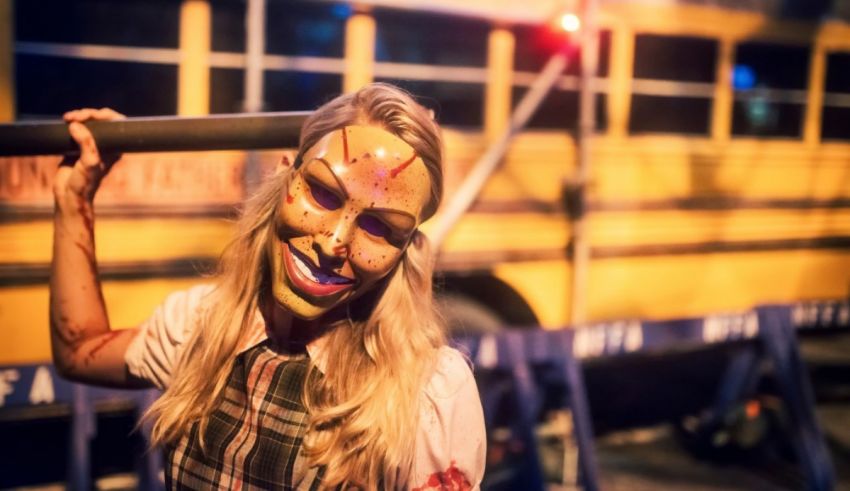 A woman in a mask holding a school bus.