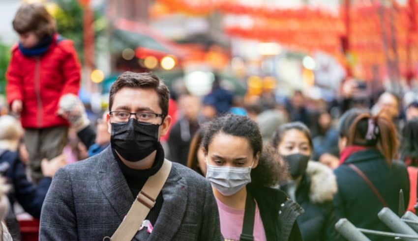 A man and woman wearing face masks.