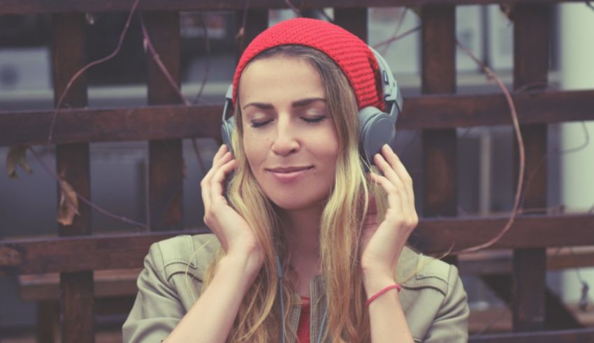 A woman wearing headphones and smiling.
