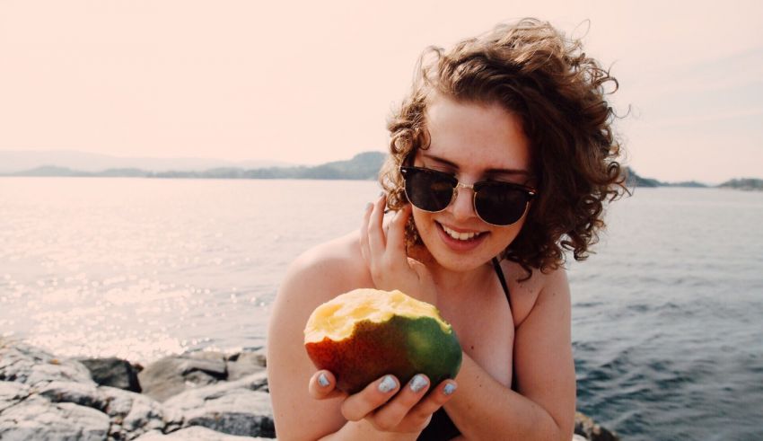A woman holding a mango.