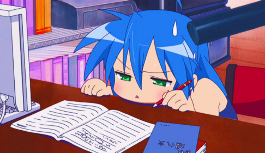 A girl with blue hair sitting at a desk with a book.