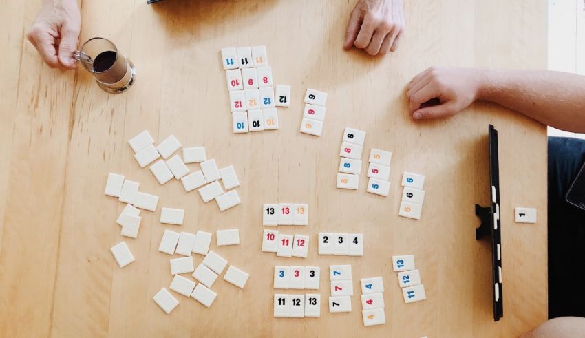 A group of people playing a game of dominoes.