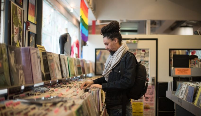 A woman looking at records in a record store.