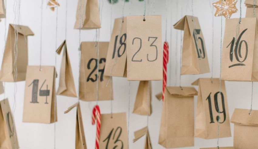 A bunch of paper bags hanging from a string on a wall.