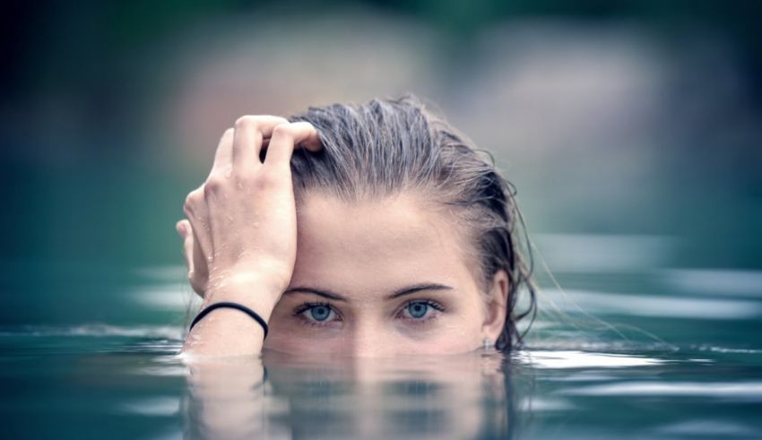 A young woman with her head in the water.