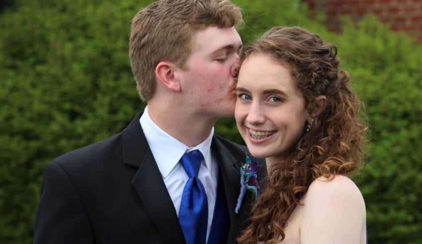 A man kissing a woman on the cheek.