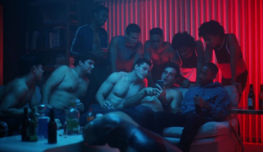 A group of men in a room with red lights.