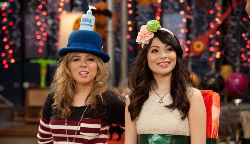 Two girls in hats standing next to each other.