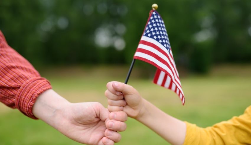 A man and a child holding an american flag.