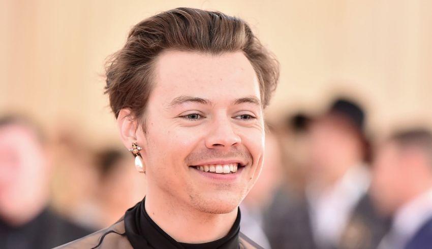 A young man smiling in front of a crowd.