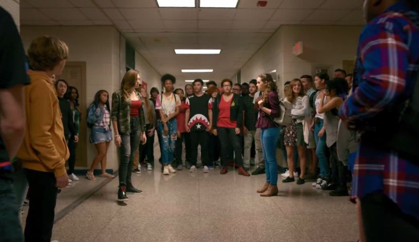 A group of people standing in a hallway.