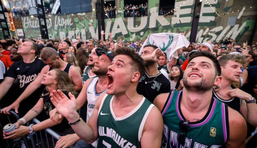 Fans of the milwaukee bucks cheer on their team during a game.