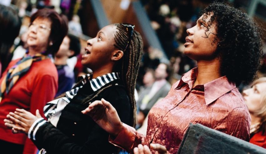 A group of women are singing in a church.