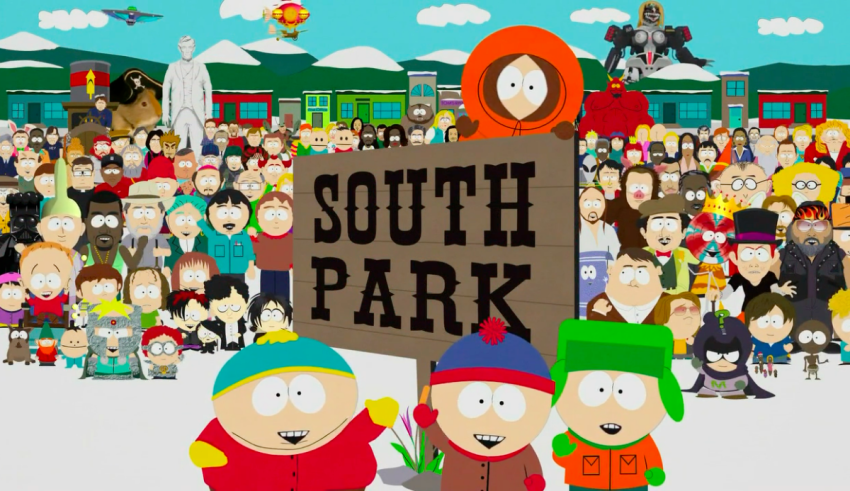 A group of people standing in front of a sign that says south park.