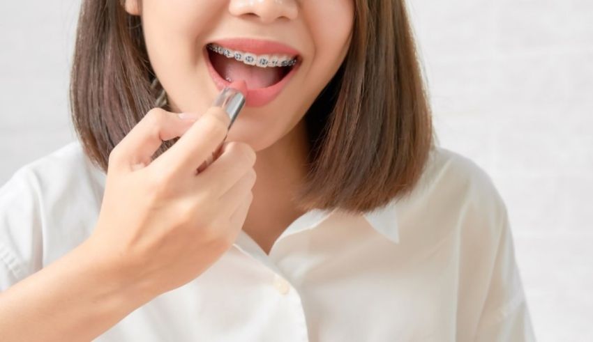 A woman is brushing her teeth with a toothbrush.