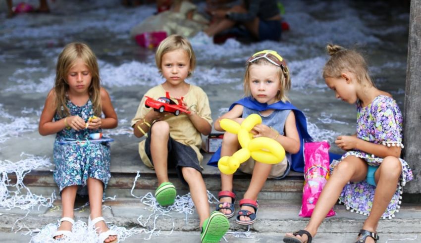 A group of children playing with balloons and toys.