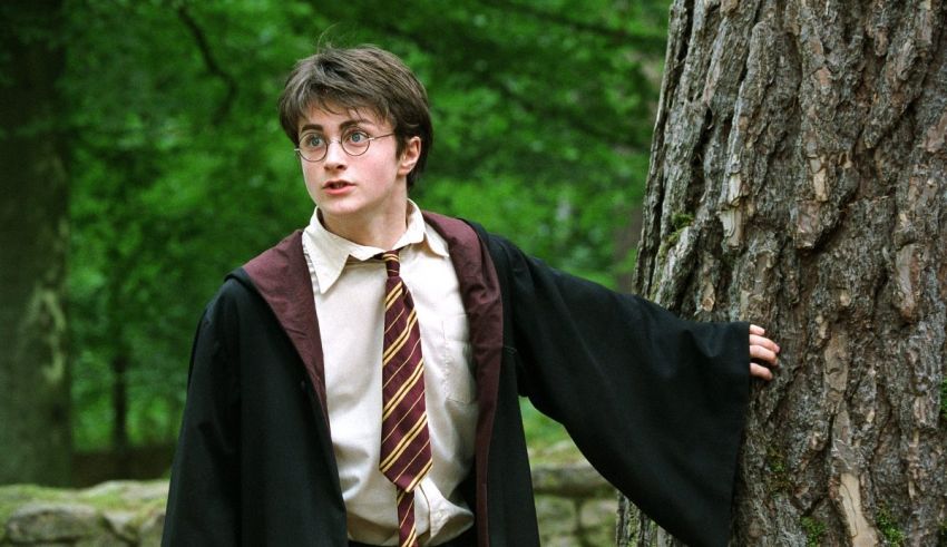 Harry potter leaning against a tree.