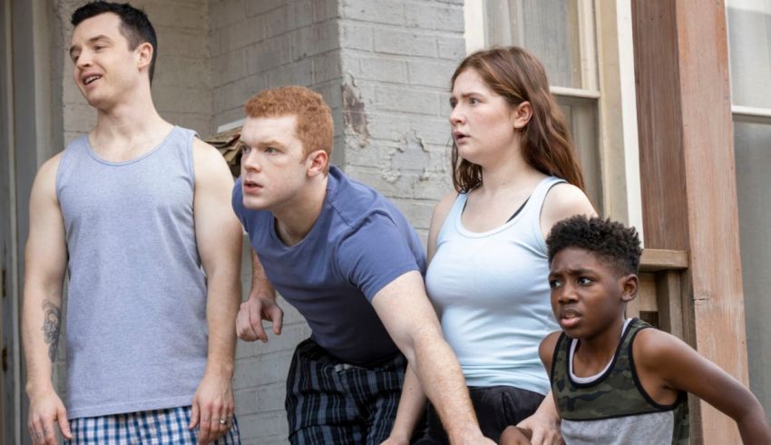 A group of people standing in front of a house.