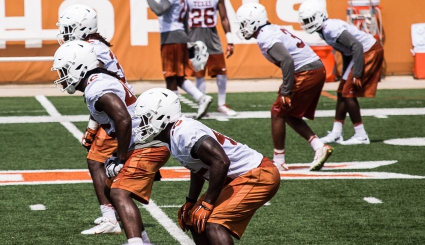 Texas longhorns football players practicing on the field.