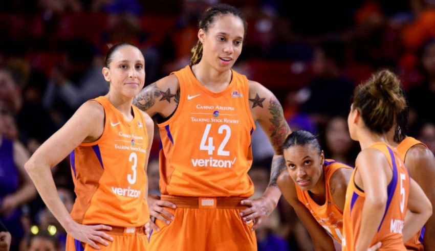 A group of women in orange uniforms standing together.