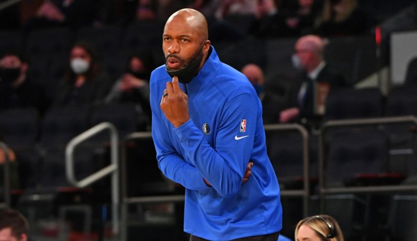 An nba coach standing on the sidelines of a game.