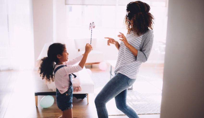 A mother and daughter playing with a toy in a living room.