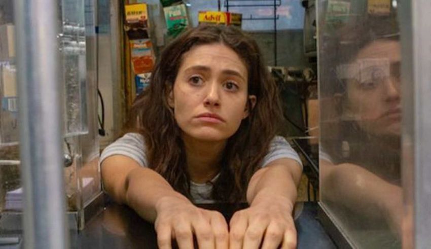 A woman leaning over a counter in a restaurant.