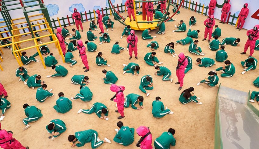 A group of people in pink uniforms in a playground.