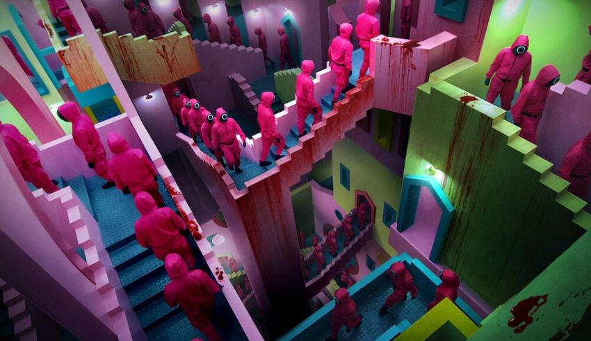 A group of people are walking down a hallway in a pink building.