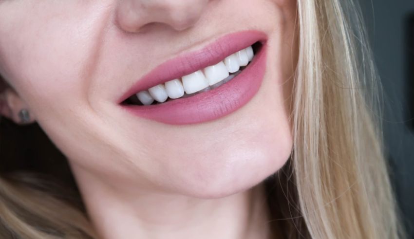 A close up of a woman with a pink smile.