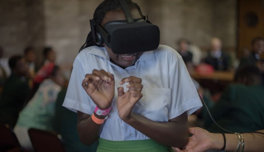 A girl wearing a virtual reality headset in a classroom.