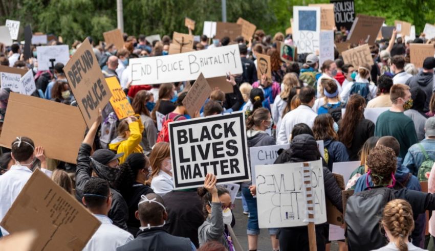 A group of people holding signs that say black lives matter.