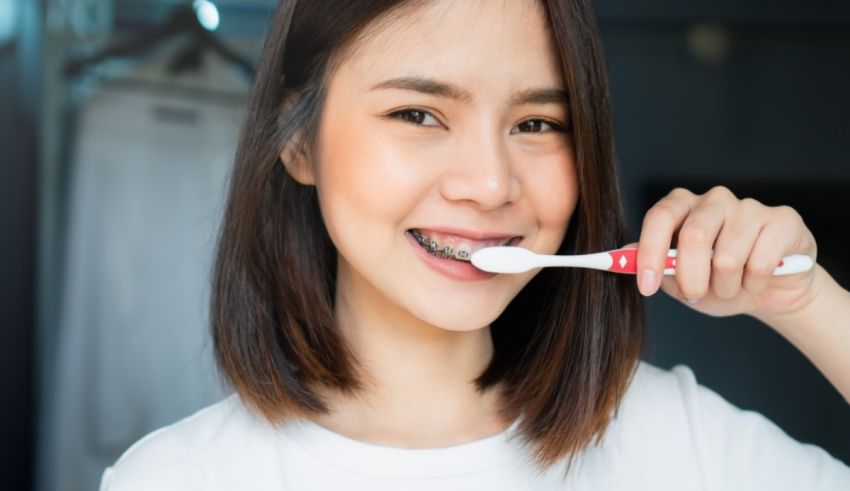 A woman is brushing her teeth with a toothbrush.
